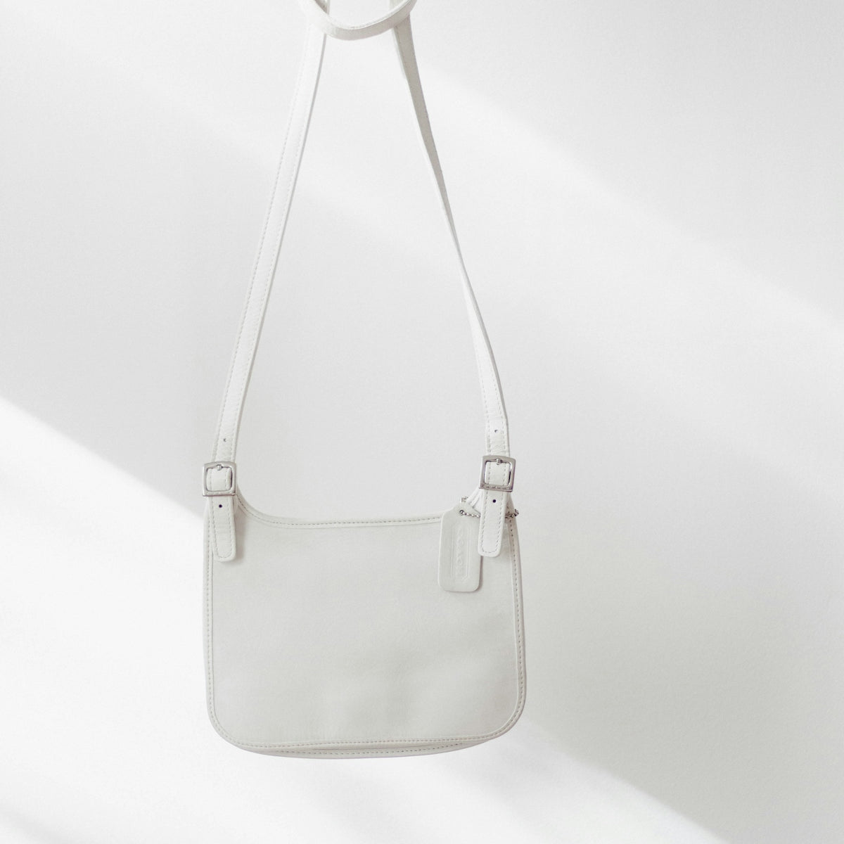 white leather handbag on white surface