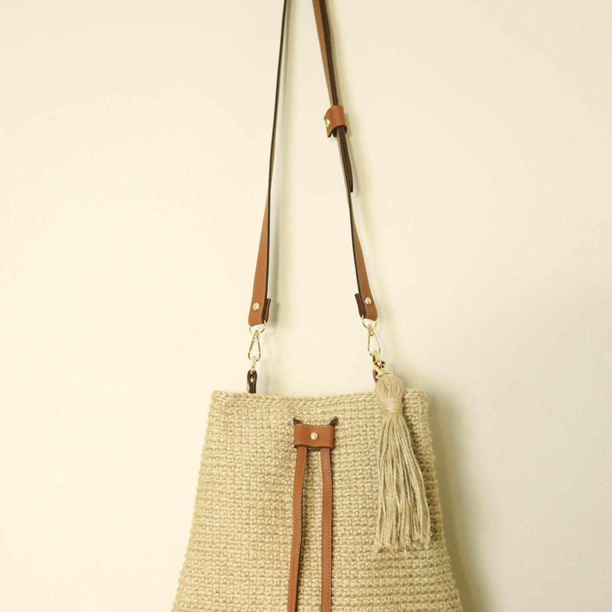 a straw bag hanging on a wall