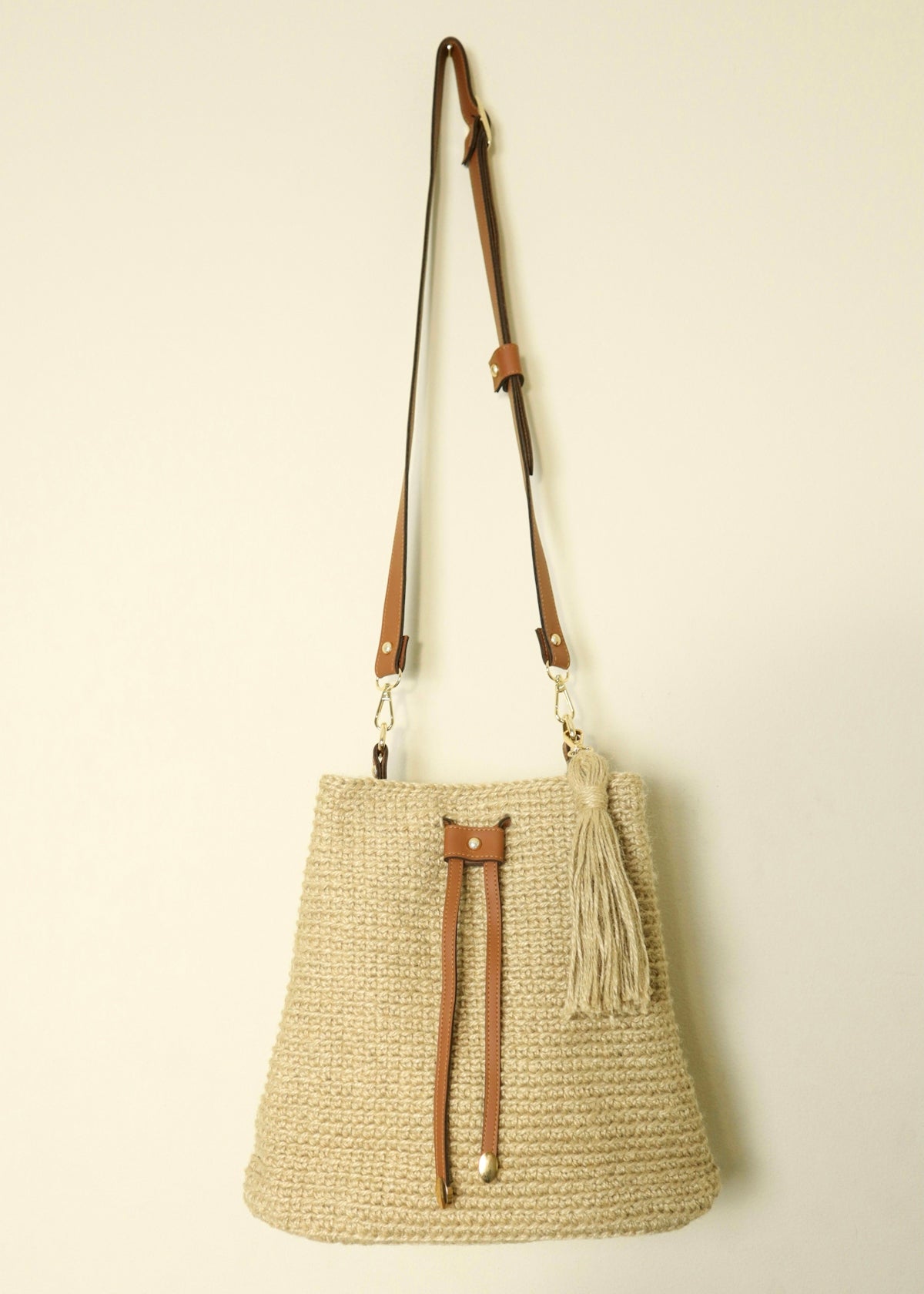 a straw bag hanging on a wall