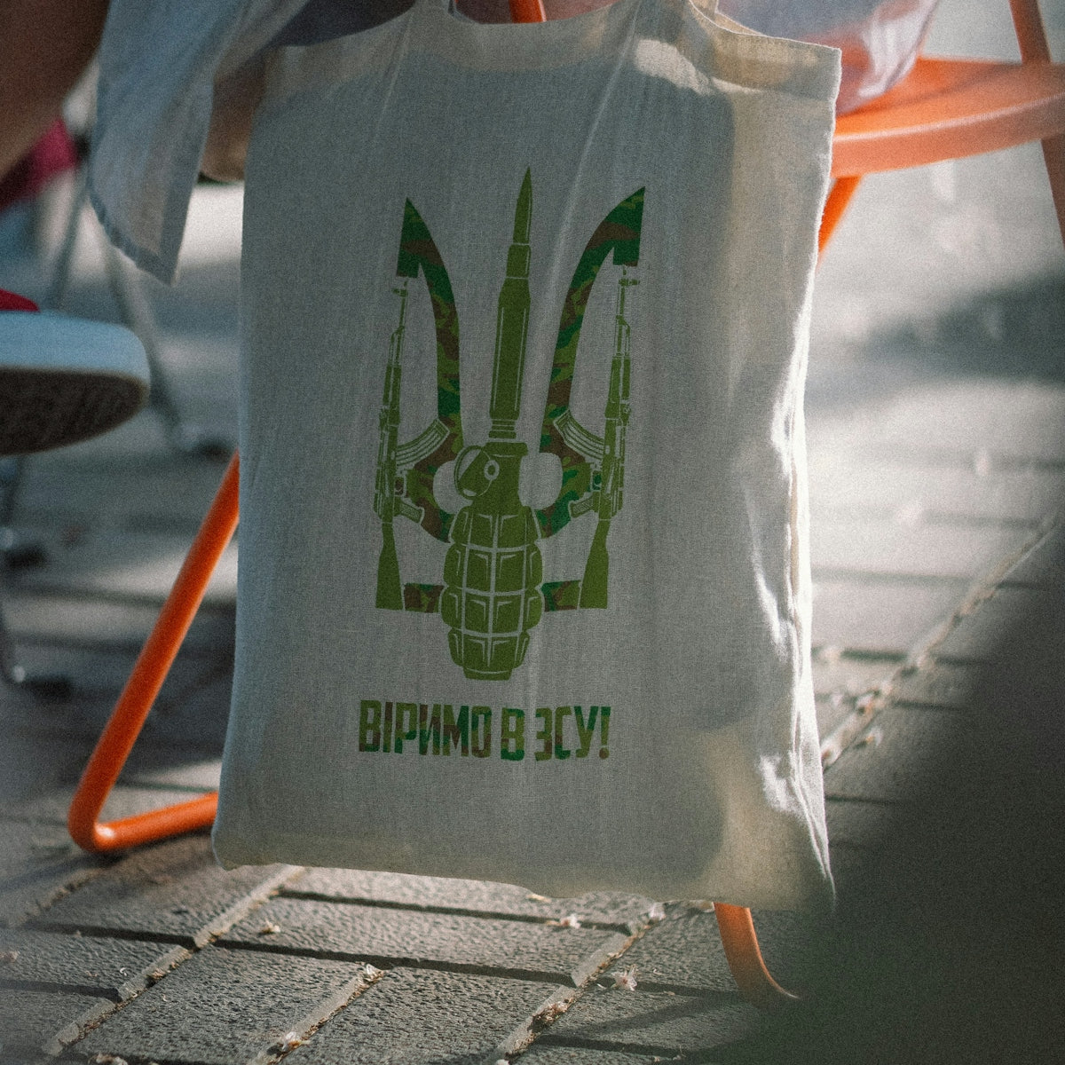 a white bag with a green logo on it