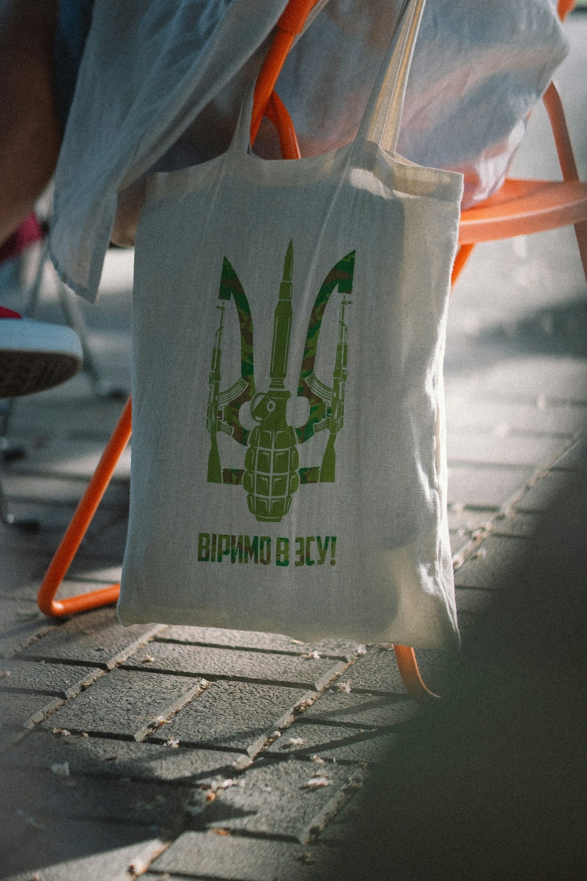 a white bag with a green logo on it