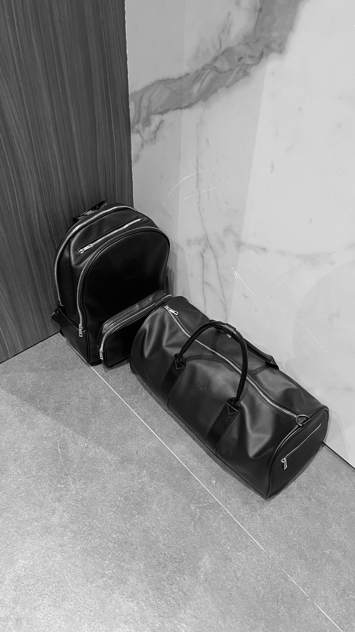 a black bag sitting next to a white wall