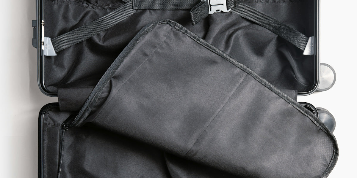 a suit case is open on a white surface