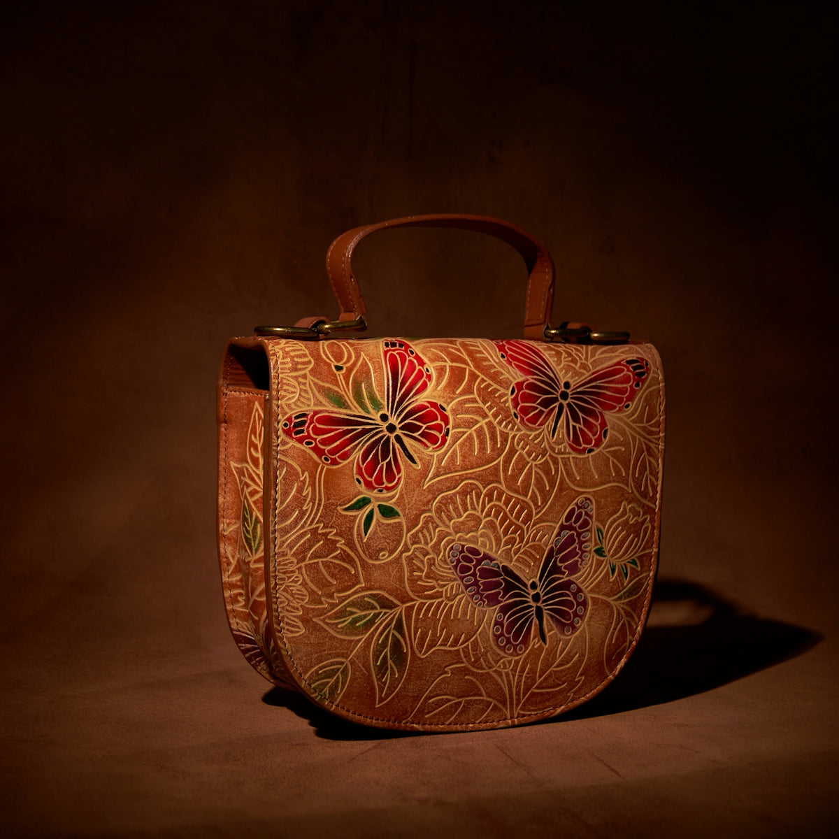 a handbag with a butterfly design on it