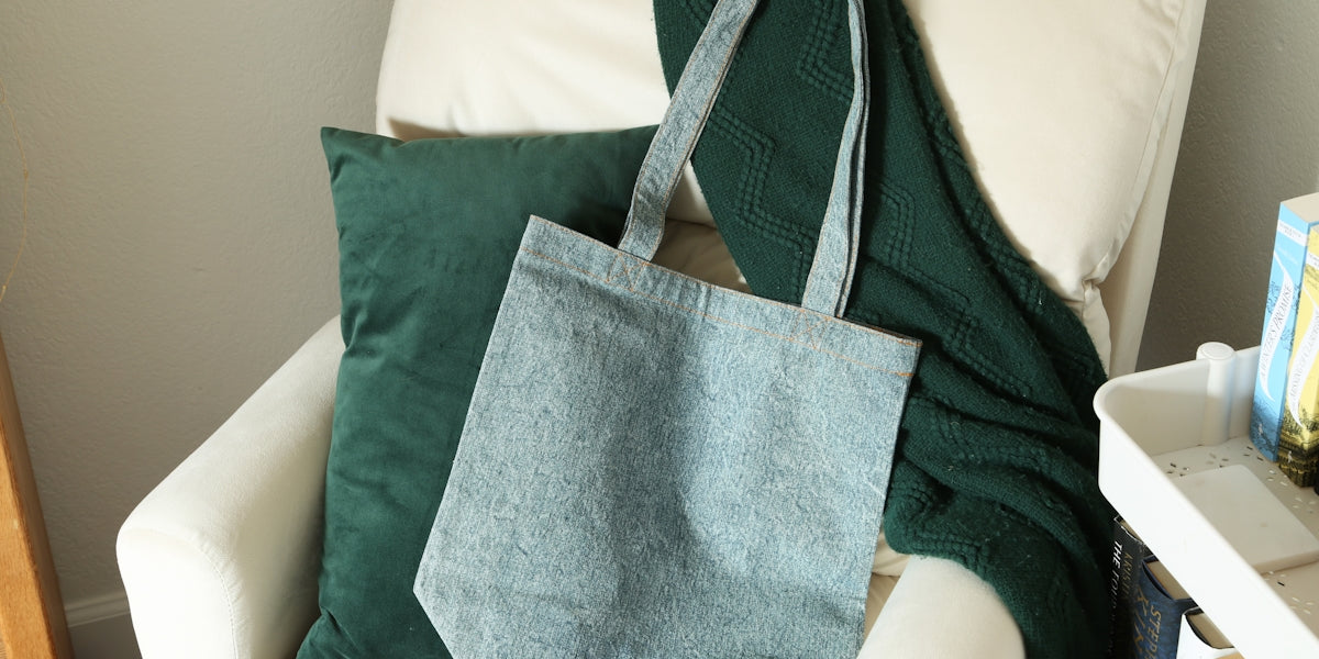 a blue bag sitting on top of a white chair