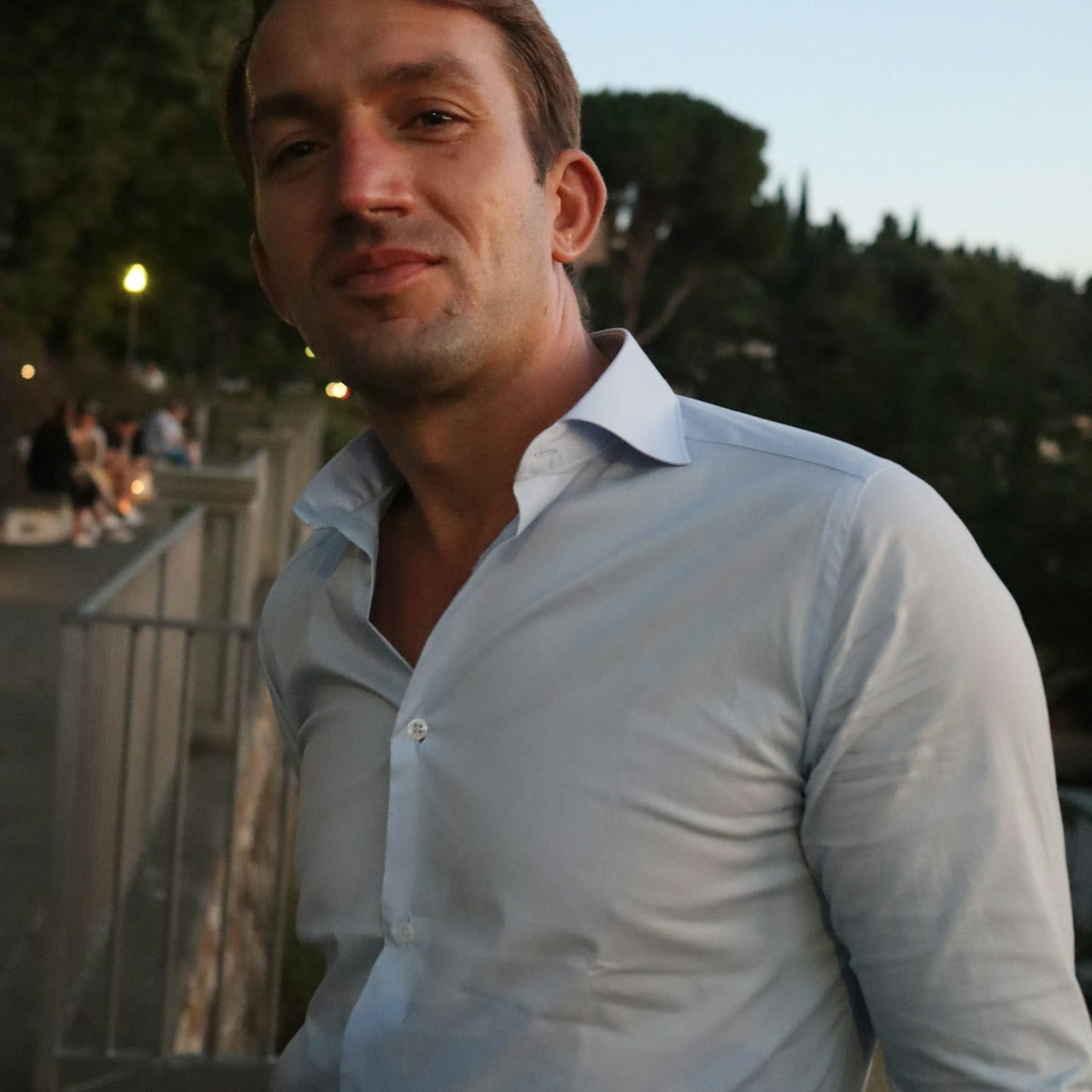 a man in a white shirt is posing for a picture