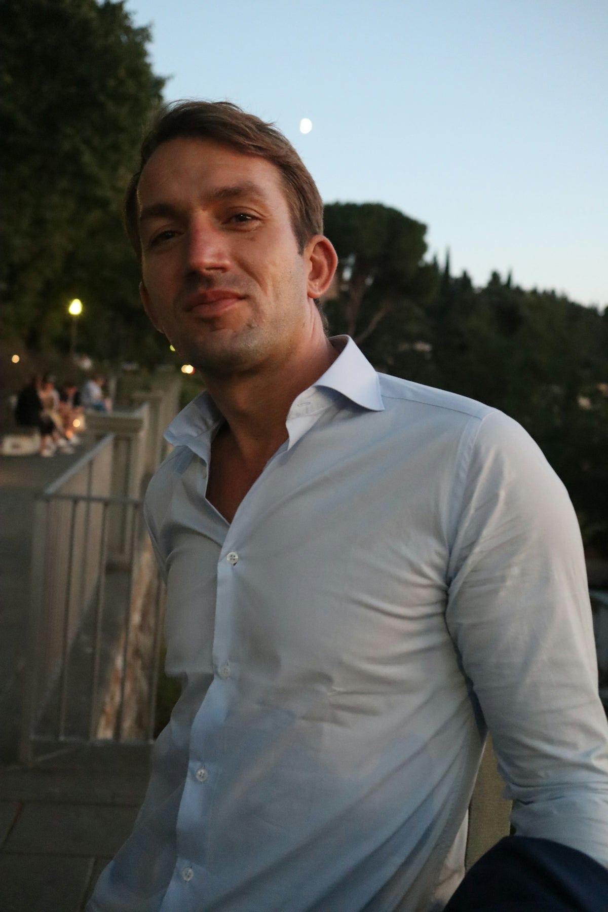 a man in a white shirt is posing for a picture