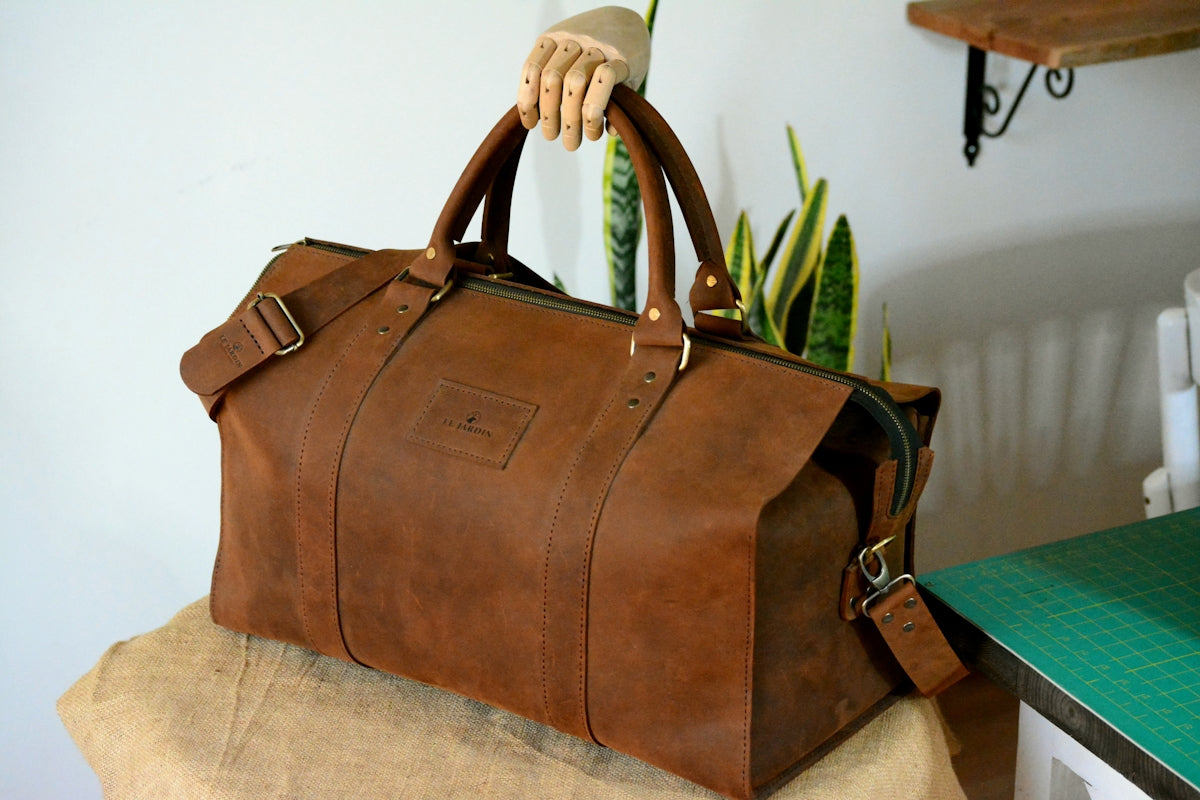 A brown leather bag sitting on top of a table