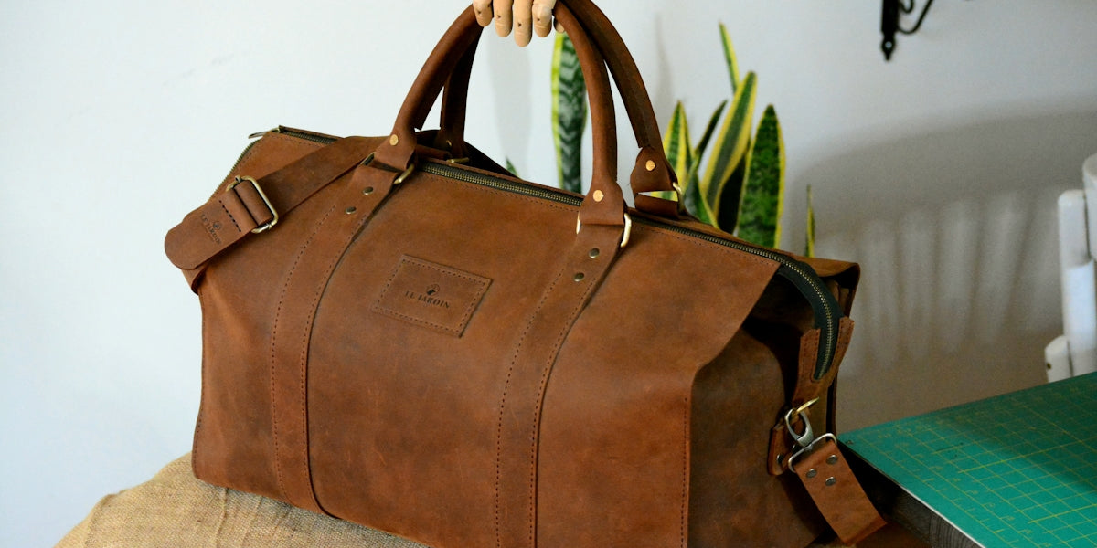 A brown leather bag sitting on top of a table