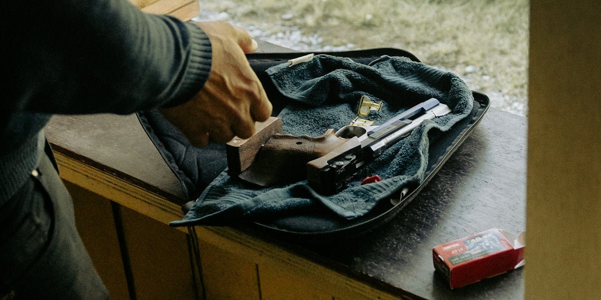 Person loading a handgun at a shooting range.