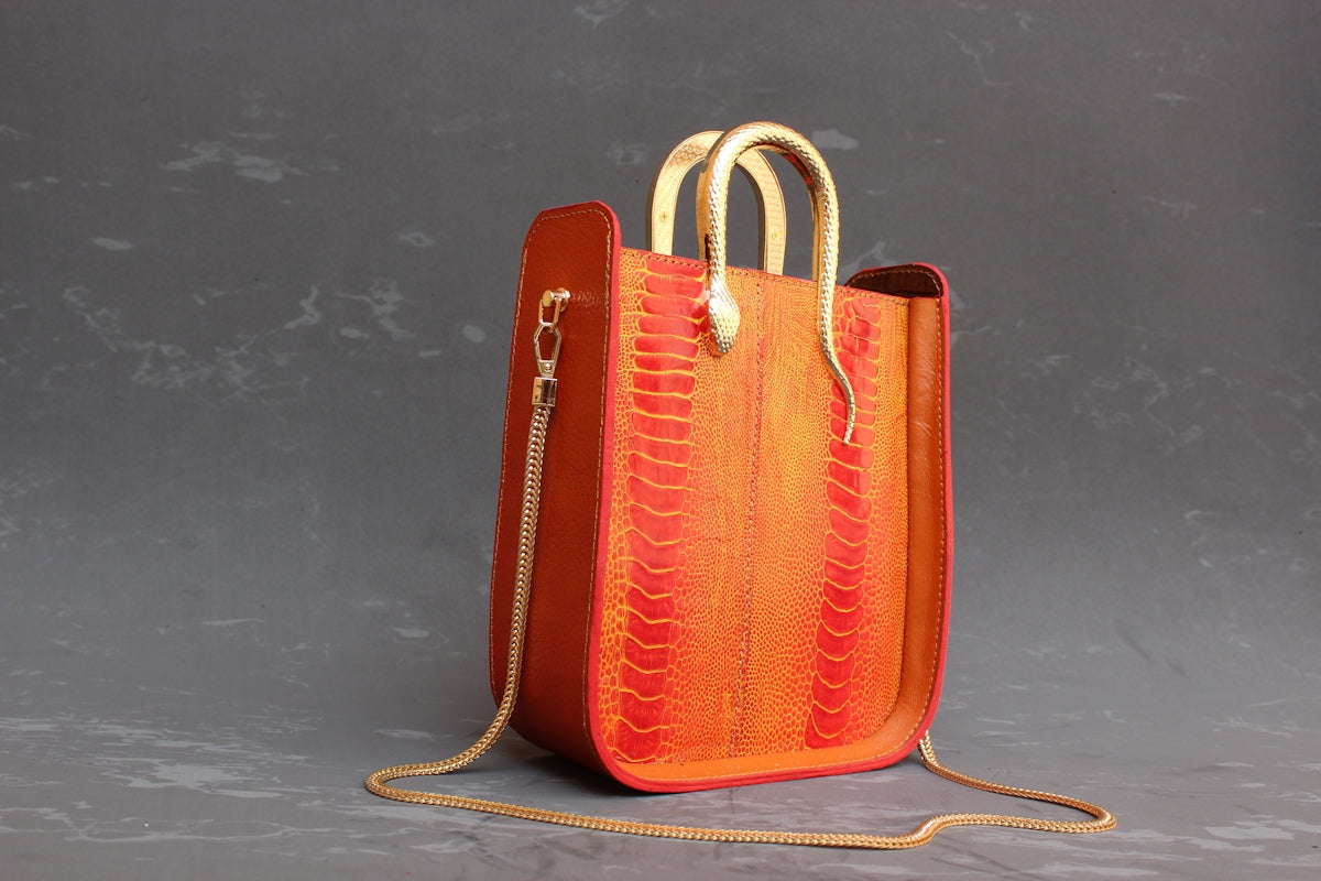 A textured leather tote bag with tan handles.