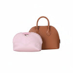 Pink inner bag organizer in front of a brown luxury handbag on white background.