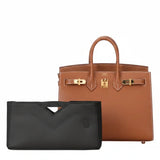Black inner bag organizer in front of a brown luxury handbag with gold hardware