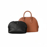 Black eco-friendly inner bag displayed in front of a brown luxury handbag on white background