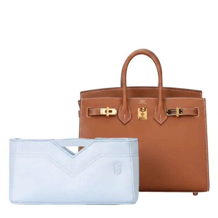 Light blue inner bag organizer placed in front of a brown luxury handbag