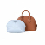 Eco-friendly white inner bag and brown luxury handbag against white background