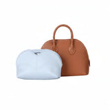 Eco-friendly white inner bag and brown luxury handbag against white background